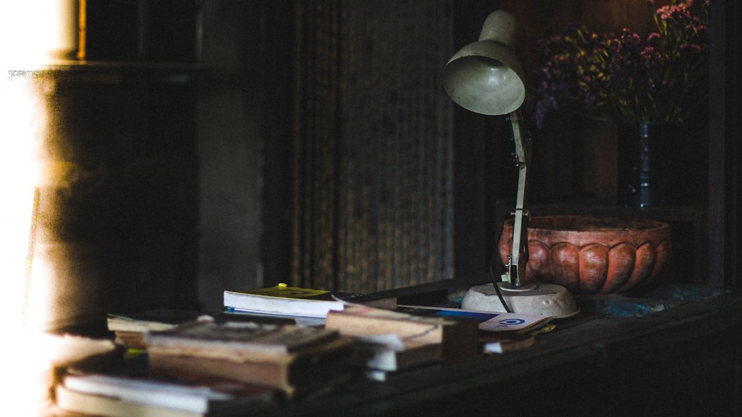 detective reading book by lamp
