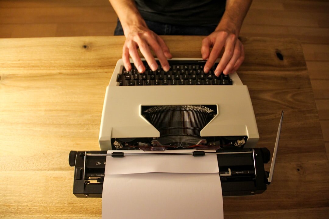 writer typing on old typewriter